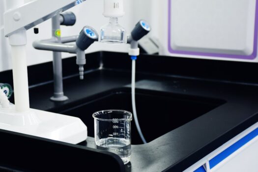 A close-up of a reverse osmosis water filtration system with clear tubing and water flow, showcasing the technology used for purifying drinking water.