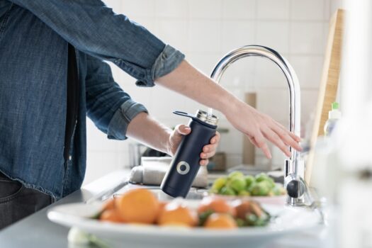 A modern kitchen with a water filtration system installed under the sink, showcasing clean drinking water and a healthy lifestyle.