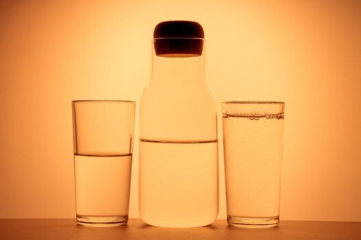 A side-by-side comparison of under sink and countertop water filters in a modern kitchen setting.