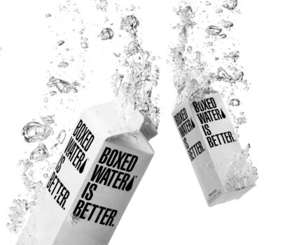 Close-up of a water filter with visible micron rating specifications and clean water flowing through it.